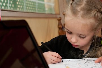 Image showing Little cute girl is drawing