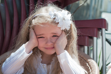 Image showing Beautiful girl squinting in the sun