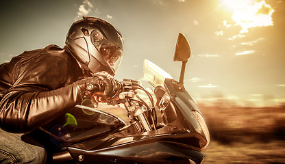 Image showing Biker racing on the road