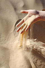 Image showing Sand slipping through fingers