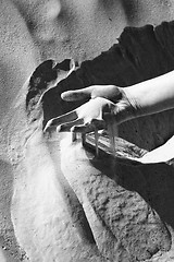 Image showing Hand in Saharas sand black and white