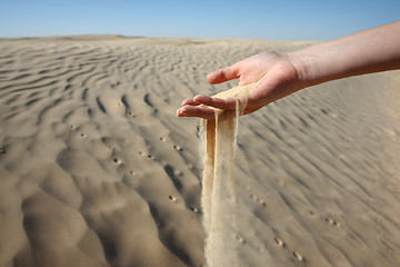 Image showing Woman hand in the sand