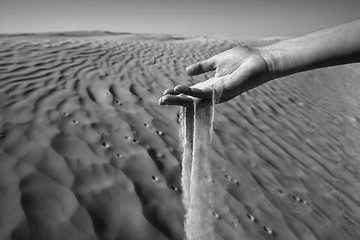 Image showing Womans hand in the sand black and white