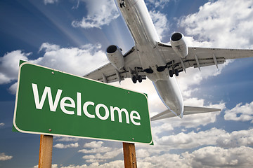 Image showing Welcome Green Road Sign and Airplane Above