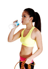 Image showing Exercise girl drinking water.
