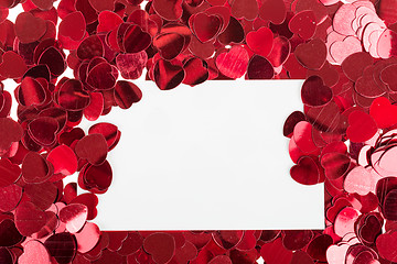 Image showing small red confetti and big hearts on white background