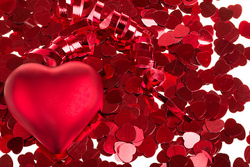 Image showing small red confetti and big hearts on white background