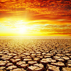 Image showing red sunset over drought earth