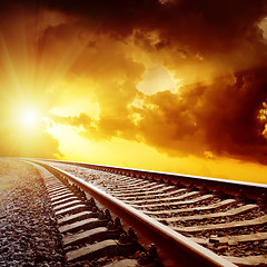 Image showing sunset with dark clouds over railroad