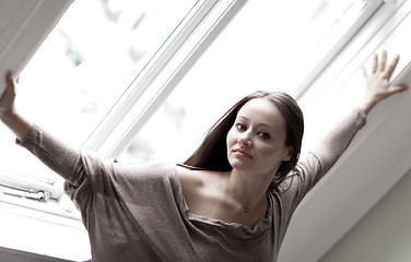 Image showing Young woman at a window 