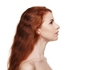Image showing Side view closeup of beautiful redheaded woman looking forward