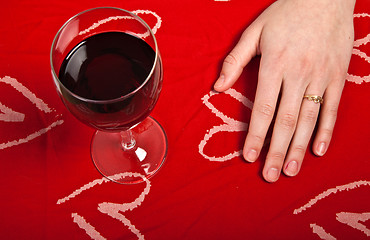 Image showing Scandinavian cute young girl hands shaping a heart and wine glas