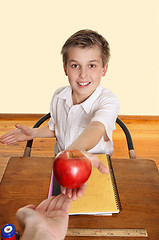 Image showing Student giving teacher an apple