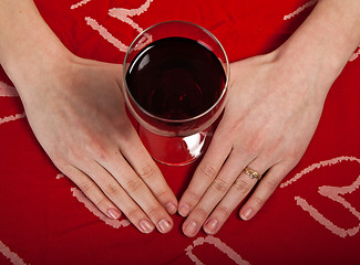 Image showing Scandinavian cute young girl hands shaping a heart and wine glas