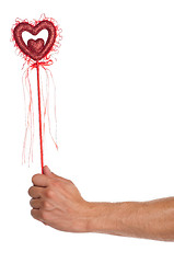 Image showing Hand with heart on a stick