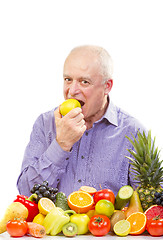 Image showing senior man eating a green apple