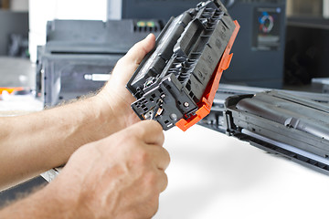 Image showing Hands repairing toner cartridge