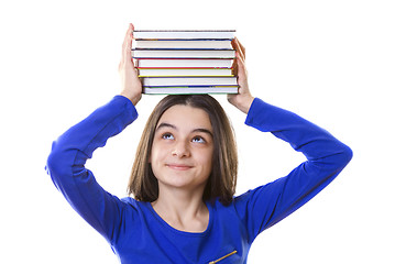 Image showing Young girl with stack of books on her head 
