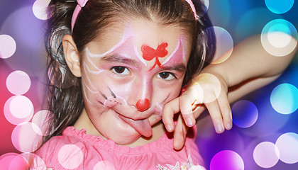 Image showing A YOUNG GIRL WITH HER FACE PAINTED