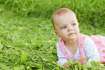 Image showing Sweet baby girl lying on grass