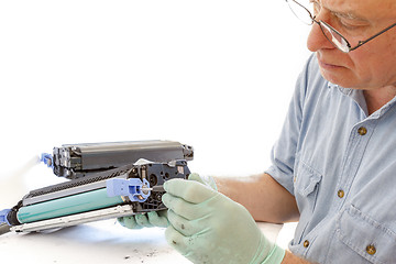 Image showing adult man working toner cartridge