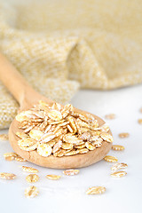 Image showing close up of oat flakes in wooden spoon 