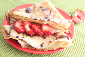 Image showing pancakes with strawberries on red plate