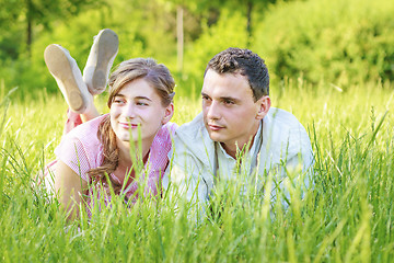 Image showing Young couple lying in park