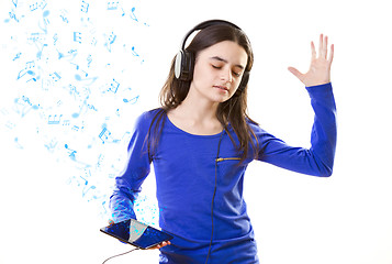 Image showing Smiling girl listening to music