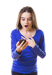 Image showing Surprised teenage girl with smartphone