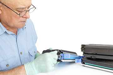 Image showing Man repairing toner cartridge