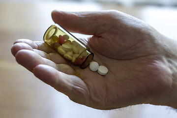 Image showing  holding pills