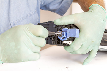 Image showing Hands repairing toner cartridge