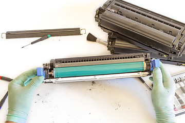 Image showing hands repairing toner cartridge