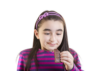 Image showing Little girl eating chocolate