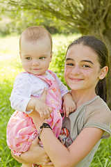 Image showing teenage girl with a baby girl