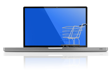 Image showing Shopping-cart over a white laptop