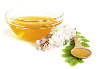 Image showing  Honey in spoon with acacia and glass bowl