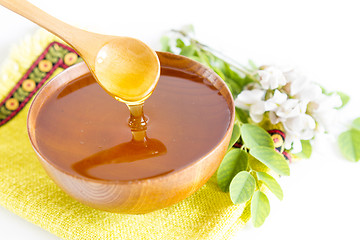 Image showing Honey in wooden bowl