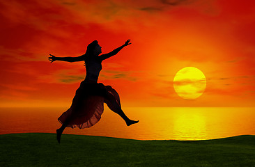 Image showing Jumping at the sunset