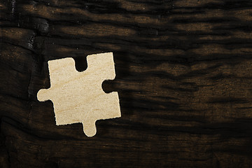Image showing Wooden puzzle on dark background. 