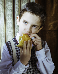 Image showing Child who eat. Vintage clothes 