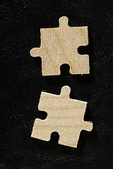 Image showing Wooden puzzle on black background