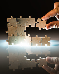 Image showing Wooden puzzle and backlight background. Close up