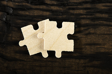 Image showing Wooden puzzle on dark background. 