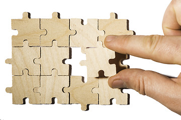 Image showing Wooden puzzle on white background. . Close up