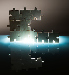 Image showing Wooden puzzle and backlight background. Close up