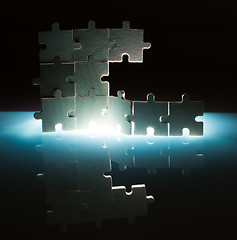 Image showing Wooden puzzle and backlight background. Close up