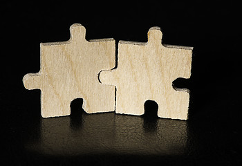 Image showing Wooden puzzle on black background