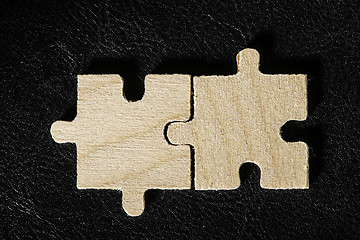 Image showing Wooden puzzle on black background